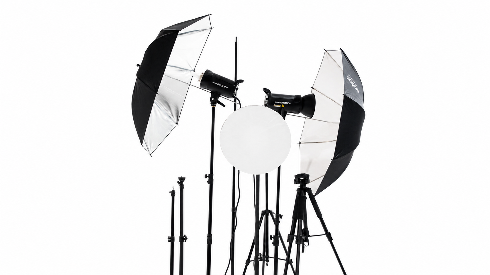 Studio strobes with silver umbrellas and beauty dish on stands